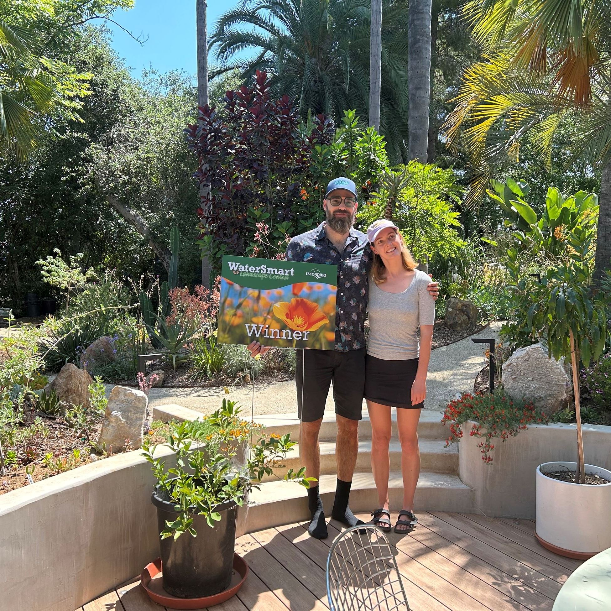 the Claermans pose with their contest winner yard sign